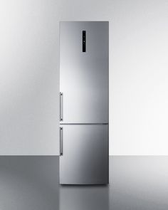 a metallic refrigerator freezer sitting on top of a metal counter next to a white wall