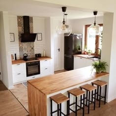 the kitchen is clean and ready to be used for cooking or eating, with stools in front of the island