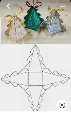 three origami christmas trees with bows on them and one is cut out to look like an origami tree