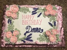 a birthday cake decorated with flowers and the words,'happy birthday domne '