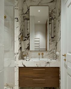 a bathroom with marble walls and flooring