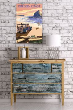 a wooden dresser sitting next to a brick wall with a poster above it that says crater lake