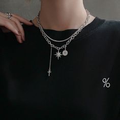 Unisex Gothic punk dark style to elevate your fashion vibes! Double layering silver chain necklace choker with crystal north star charm, cross drop pendant, and silver donut ring charm. Very chic and stylish for men and women, an eye-catching posh necklace to show your unique edgy taste. 💎 Features: ♥ Handcrafted ♥ Finish Tone: silver ♥ Side Stone: cubic zirconia ♥ Double layer, Adjustable closure ♥ Approximate Measurements: - Length: 18" with 2.5" adjustable ♥ Nickel/Lead Free, Hypoallergenic, Edgy Silver Star-shaped Jewelry, Trendy Silver Charm Necklaces, Silver Metal Chain Necklace With Star Charm, Trendy Streetwear Silver Chain Jewelry, Edgy Star Charm Jewelry As A Gift, Edgy Silver Jewelry For Streetwear, Trendy Streetwear Choker Jewelry, Silver Dangle Grunge Jewelry, Edgy Silver Jewelry With Charms