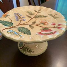 a decorative plate sitting on top of a wooden table