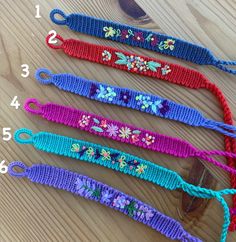 four crocheted lanyards with flowers on them