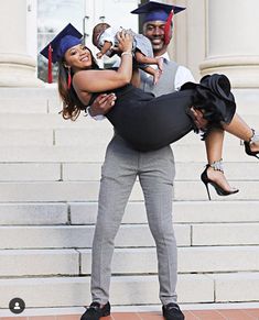 a man carrying a woman on his back while she holds her up in the air