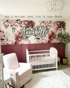 a baby's room decorated in pink and white with flowers painted on the wall