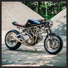 a black motorcycle parked in front of a pile of cement