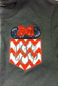 a gray shirt with red and white chevrons on the front, and a bow at the back