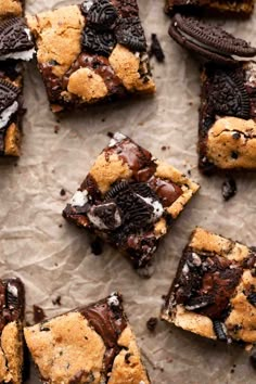 chocolate chip cookie bars with oreo cookies and ice cream toppings on parchment paper