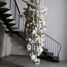 a chandelier hanging from the ceiling in front of a stair case with skulls and bones on it