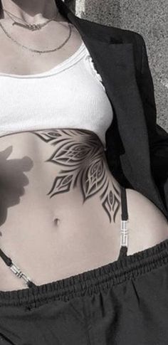 a woman with a tattoo on her stomach