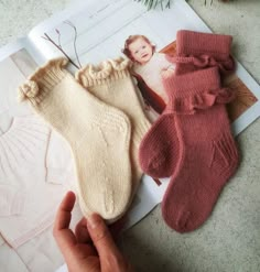 two pairs of socks are shown next to an image of a baby's head