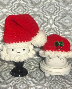 two knitted santa hats sitting next to each other