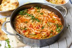 a pot filled with pasta and vegetables on top of a table