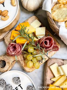 various cheeses, crackers and nuts are on the table