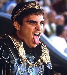 a man with his tongue hanging out in front of an audience at a sporting event