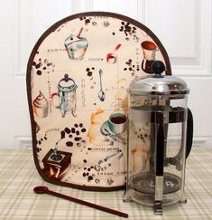 a coffee pot holder with an oven mitt next to it