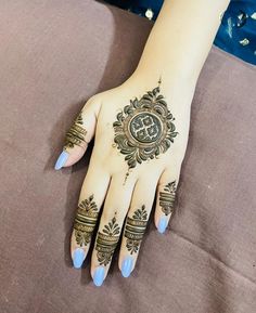 a woman's hand with henna tattoos on it