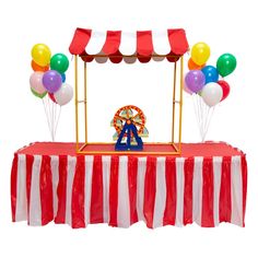 a carnival booth with balloons and a ferris wheel on the table for an adult birthday party