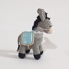 a small crocheted donkey with a saddle on its back