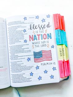 an open bible with colorful markers on it and the words, blessing is the nation whose god is the lord