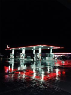 the gas station is lit up at night