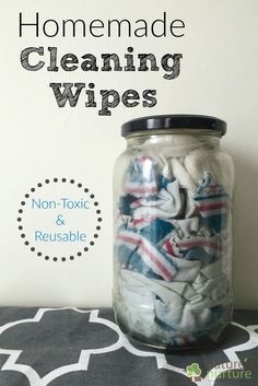 a jar filled with cleaning wipes sitting on top of a black and white table cloth