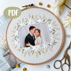 a wedding photo in a frame with flowers and scissors