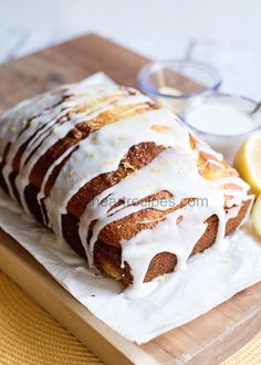 a loaf of lemon bread with icing on a cutting board