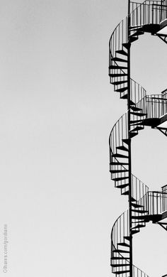 a black and white photo of a spiral staircase with pinteres logo on it