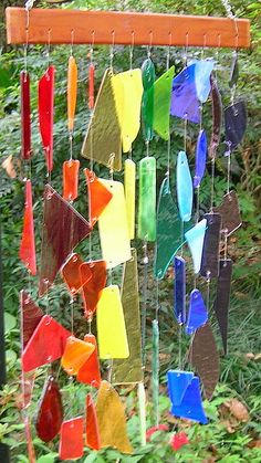 a colorful wind chime hanging from a wooden pole