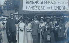 an old black and white photo of people holding up a sign that says women's surface society lands end to london