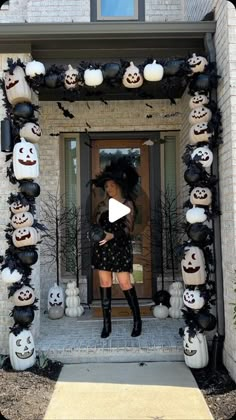 a woman standing in front of a doorway decorated with halloween decorations