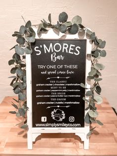 there is a sign that says s'mores bar and it has leaves on it