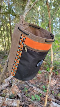 Do you need an awesome bag to hold your gear? Do you love a handcrafted waxed canvas piece of gear? Then our Two Tone Bucket Bag in Brown and Black is perfect for you. This waxed canvas round-bottomed bag has a 6.5' diameter and is 9.5" tall. The bag closes with a paracord and a toggle. This bag is perfect for holding all kinds of gear or for packing your favorite snacks. This one is a bit special because we added a zipper pocket to the front and vintage woven trim with a pop of orange. this is a one of a kind bucket bag. It even has a leather loop so you can hang it open. Each bag is designed, created and assembled in our small shop in the beautiful Pacific Northwest. No two bags are exactly alike but all are made with great care and the intent that the item will be with you for a long ti Canvas Bucket Bag, Waxed Canvas Bag, Chalk Bags, Bucket Bags, Bag Ideas, Waxed Canvas, Pacific Northwest, Fun Bags, Paracord