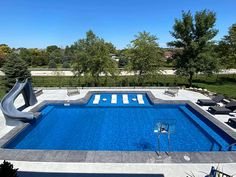 an empty swimming pool surrounded by lawn chairs