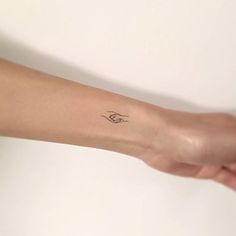 a woman's arm with a small tattoo on the left side of her arm