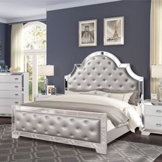 a bedroom with blue walls and white furniture