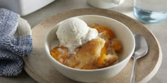 a bowl filled with fruit and ice cream on top of a plate