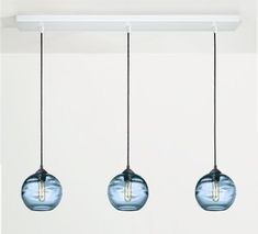 three glass globes hanging from a ceiling