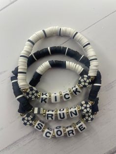 three bracelets with black and white letters on them