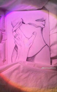 a drawing of a person holding their head in front of a rainbow colored light on a bed