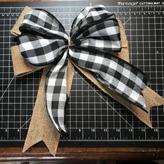 a black and white bow sitting on top of a cutting board