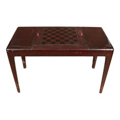 a wooden table with a chess board on it's top and two legs in the middle