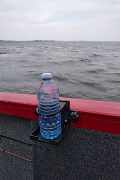 two water bottles sitting on the edge of a boat