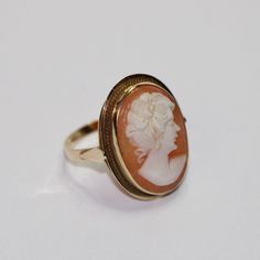 SKU: 0057 A beautiful cameo fancy ring set in 14ct yellow gold. This pretty ring would be perfect for any and every occasion. Size: UK: K 1/2 American: 5 1/2 Continental: 10 1/2 This is a vintage item and such has wear. There may be some superficial scratches, otherwise the item is good condition. This item comes beautifully boxed in our own packaging. Processing time for orders is 1-3 business days. Gold Oval Cameo Rings, Victorian Gold Cameo Rings, Cameo 14k Gold Rings For Collectors, Vintage 14k Gold Cameo Rings, Vintage Cameo Signet Ring For Anniversary, Collectible 14k Gold Cameo Rings, Vintage Gold Cameo Ring, 14k Gold Cameo Rings For Collectors, Elegant Oval Cameo Engraved Ring