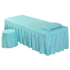 a blue bed with two matching foot stools