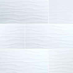 four different white tiles with wavy lines on them