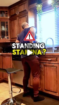 a man standing on a stool in a kitchen with the words standing stanna?